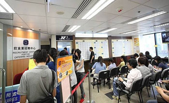 Job-seekers registering for on-the-spot job interviews with employers in the Recruitment Centre for the Catering Industry.