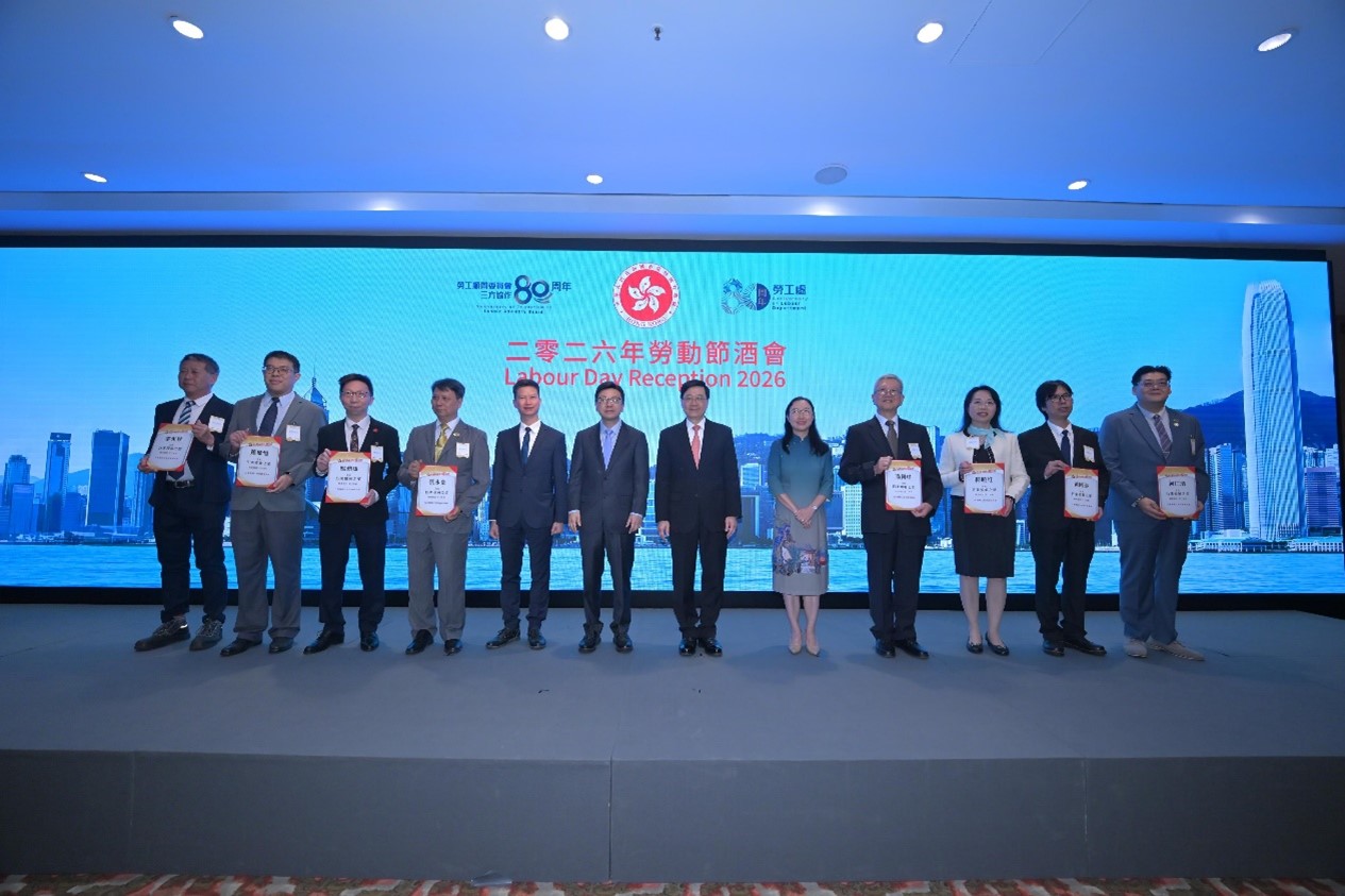 Photo shows the four officiating guests, with the eight awardees of the