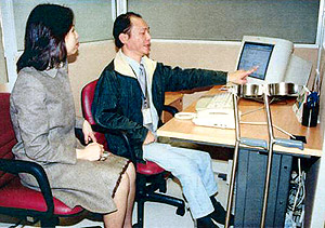 A Placement Officer visiting a tele-sales assistant placed by the Selective Placement Division.
