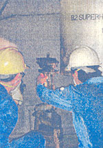 Inspecting a water-tube boiler superheater safety valve. 
