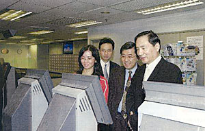 Secretary for Economic Development and Labour Mr Stephen Ip Shu-kwan trying out the facilities at a job centre. 