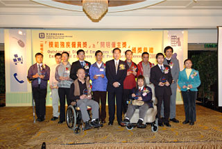 Member of the Executive Council Mr Bernard Chan (seventh from left) presents the 'Outstanding Disabled Employees Award' to 12 winners.