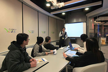 Business members discussing work plans with partners in the business room of Y.E.S..